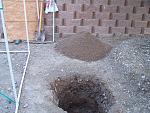 Pile of sifted soil ready for backfilling the hole